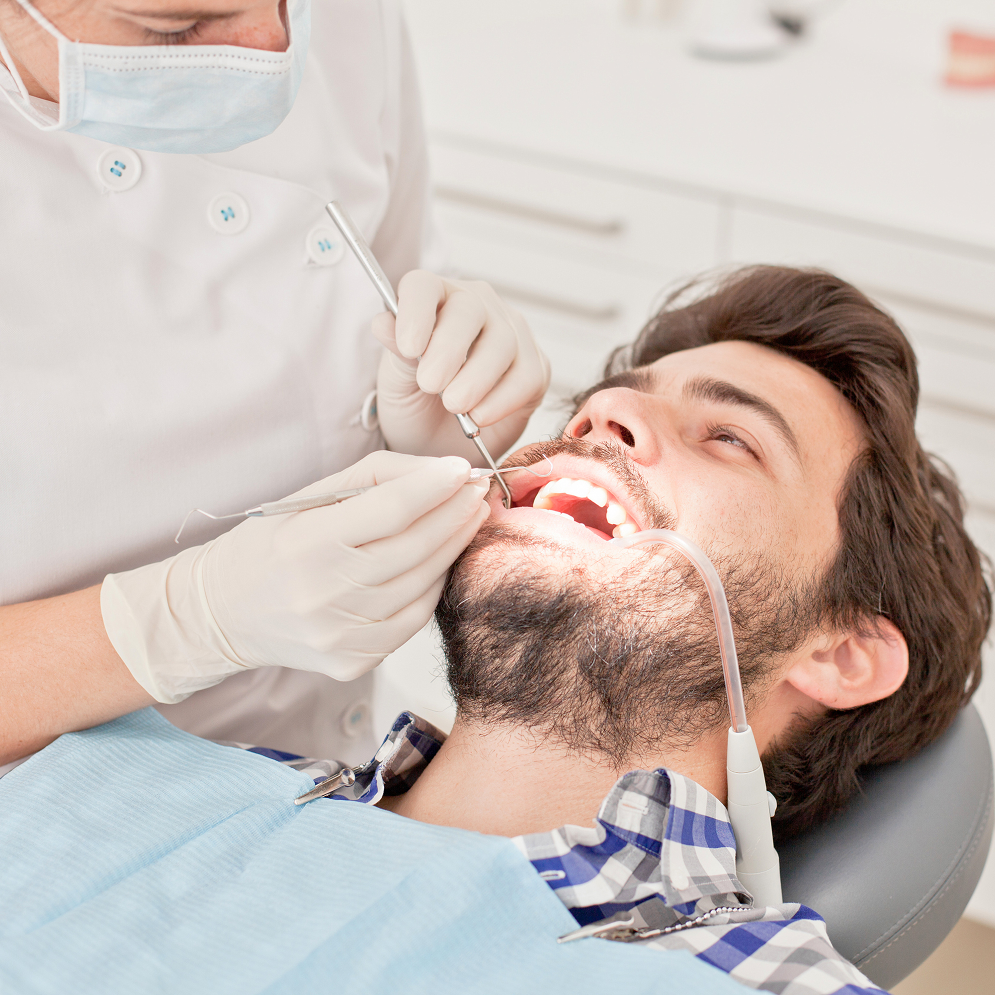 young man and woman in a dental examination at dentist
