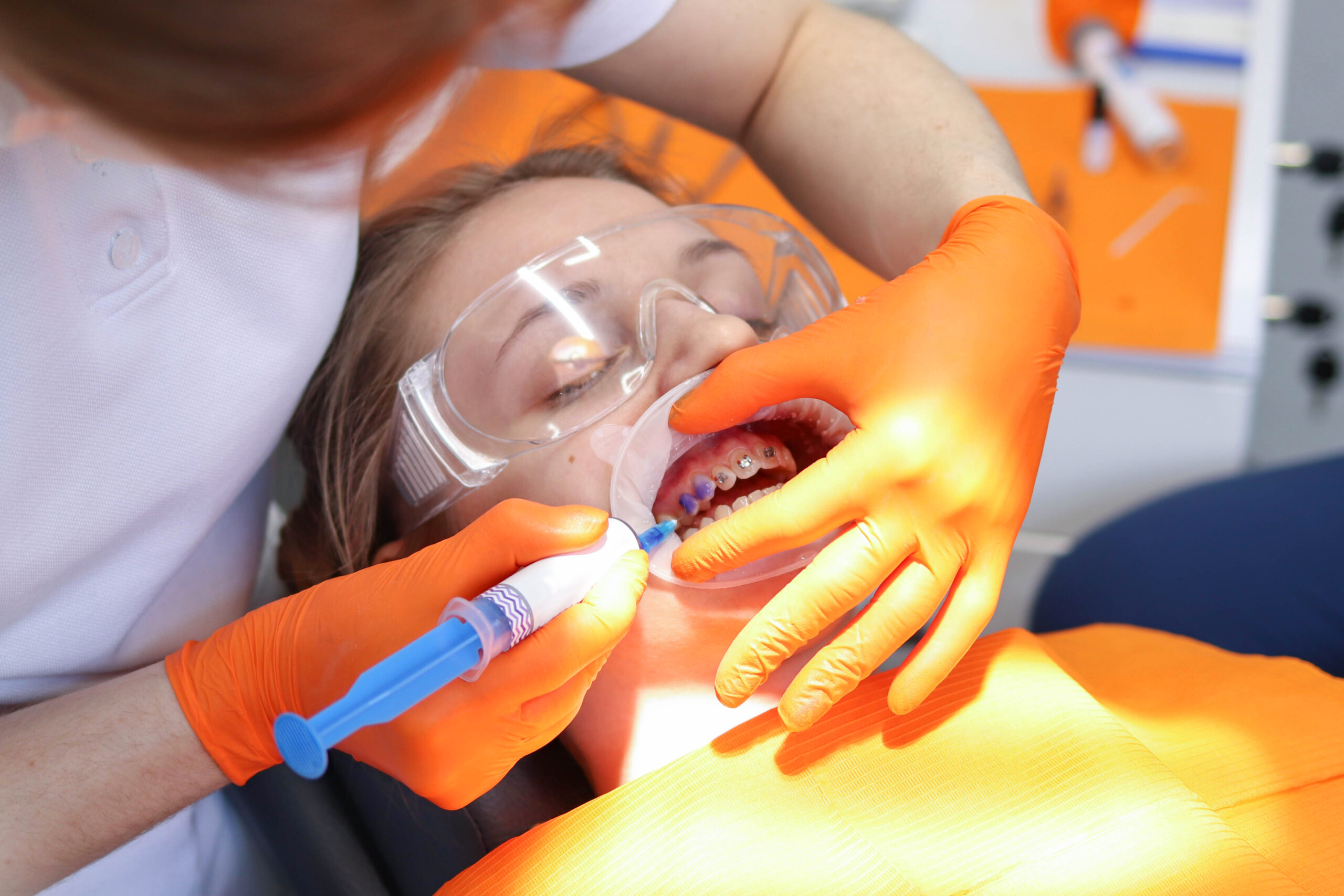Dentist's doctor installs dental braces for his patient