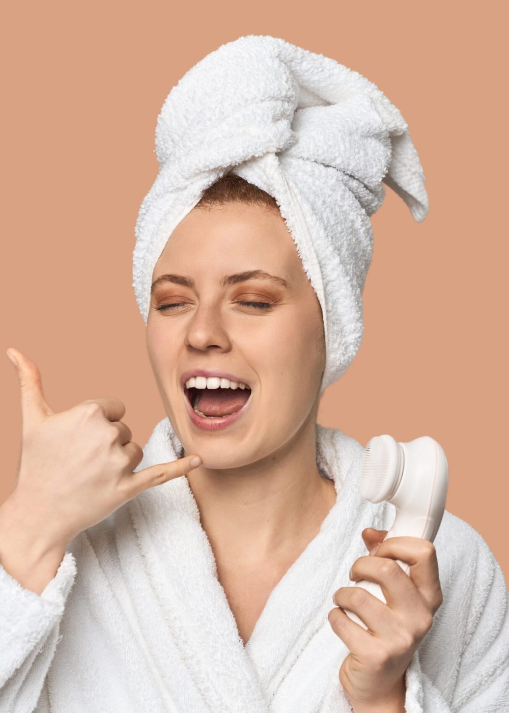Young Caucasian redhead with facial device showing a mobile phone call gesture with fingers.