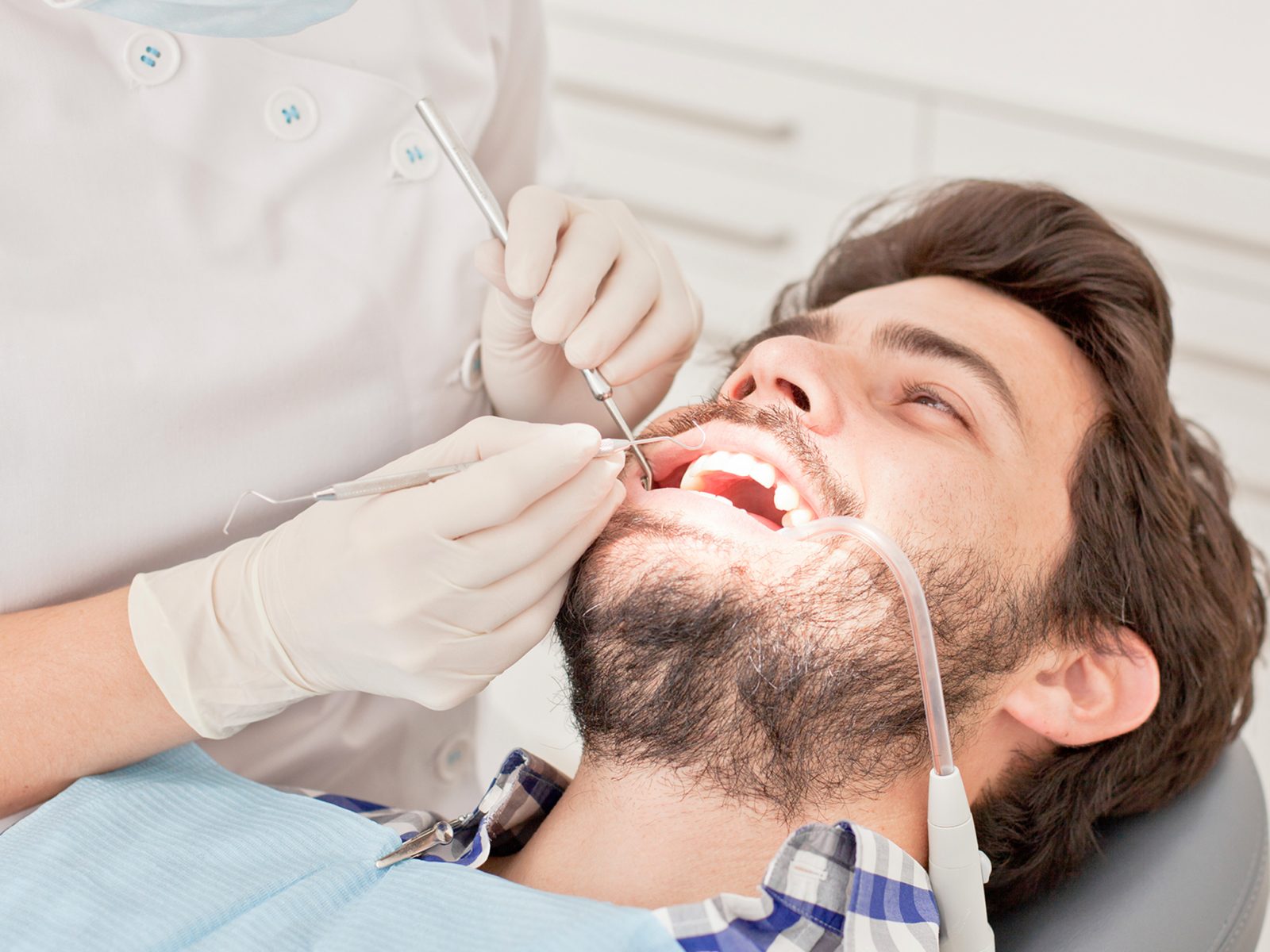 young man and woman in a dental examination at dentist